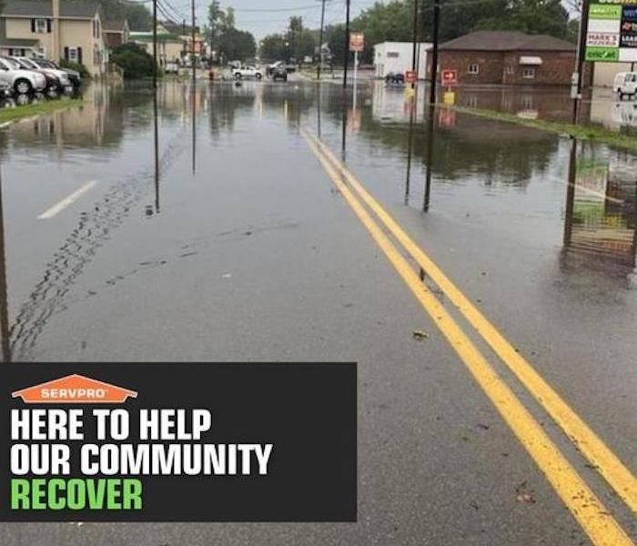 flooding on a street with SERVPRO imbedded message