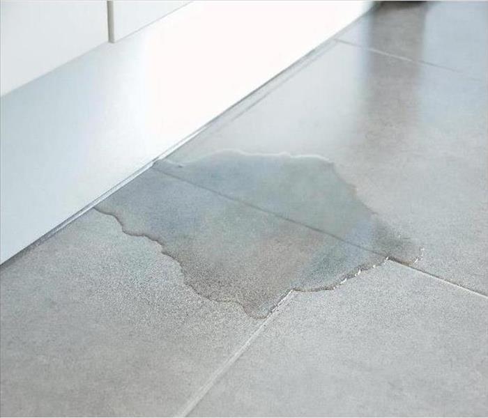 a puddle of water on the tile floor of a home